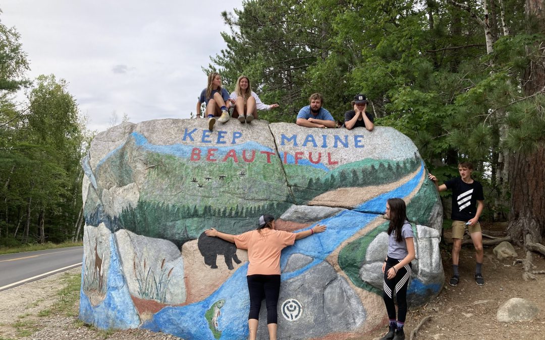 Program Manager Katlyn hugs the Keep Maine Beautiful Rock