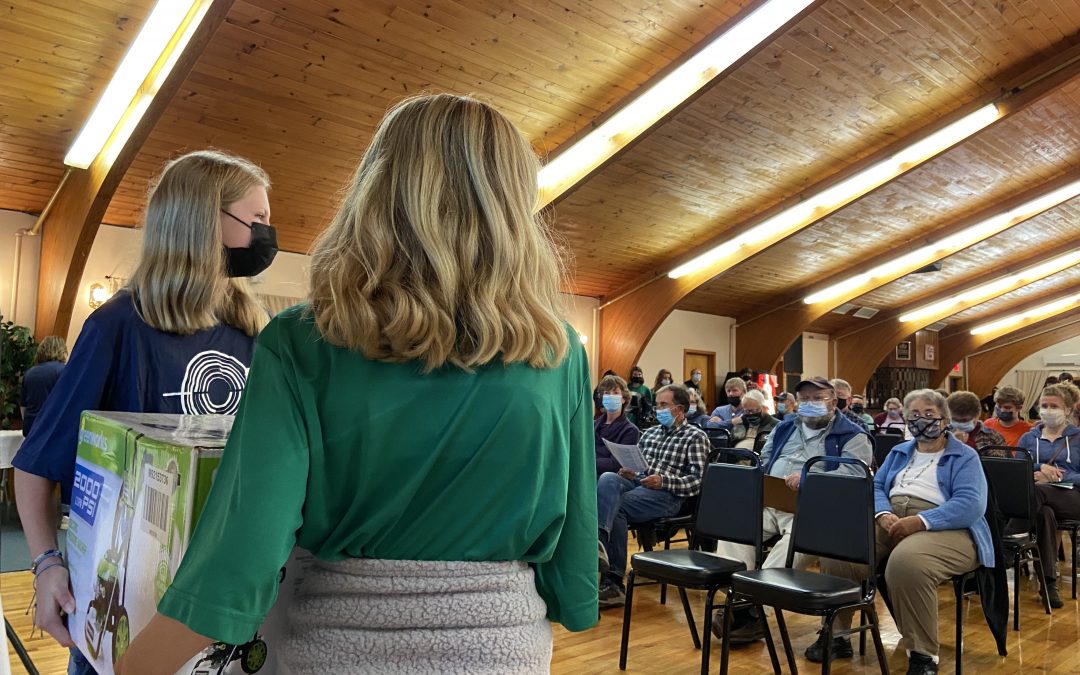 Students featuring items during the live bid auction.