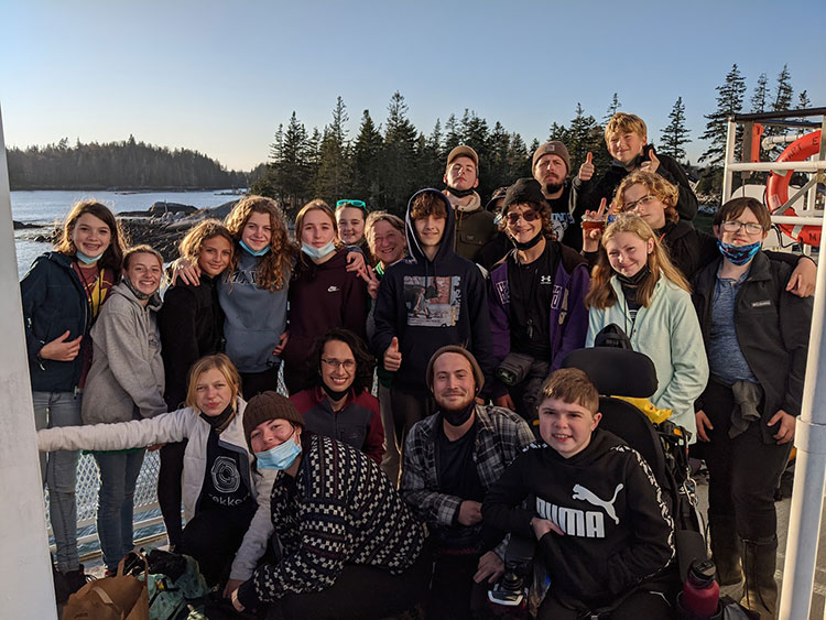 Photo of 8th grade students smiling outside