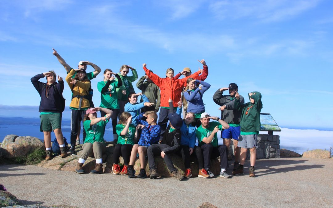 Group photo of students at Acadia National Park, being goofy by pointing in different directions