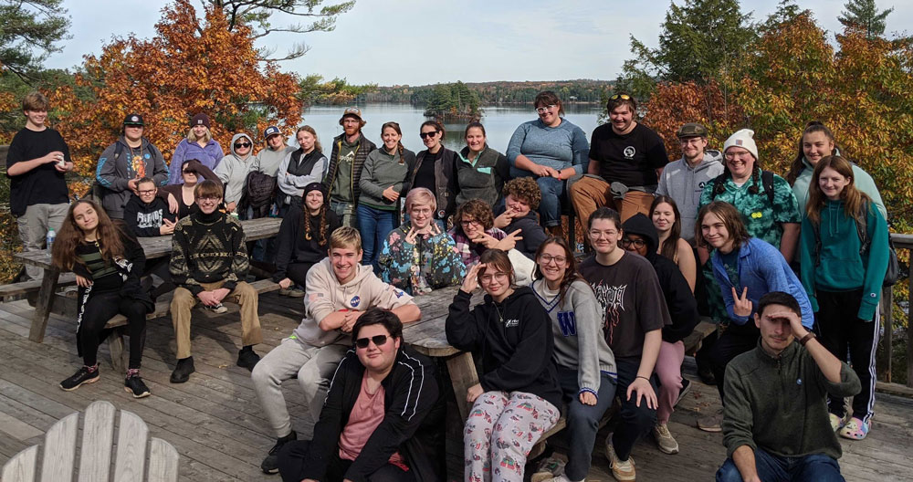 Group of students and leaders in front of a lake